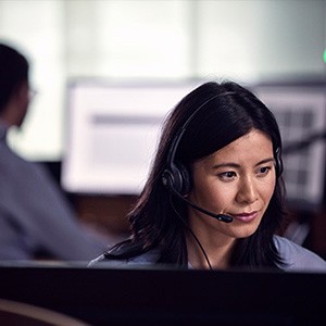 Young female office worker using a Sennheiser headset