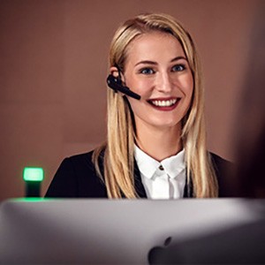 Young female worker smiles during a call