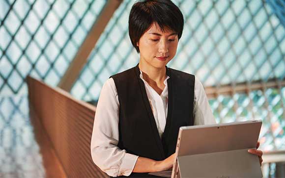 Woman working on a Surfac e device