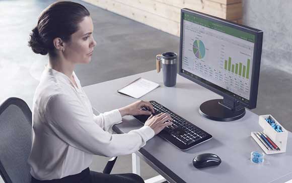 Woman working on Microsoft devices with Microsoft software