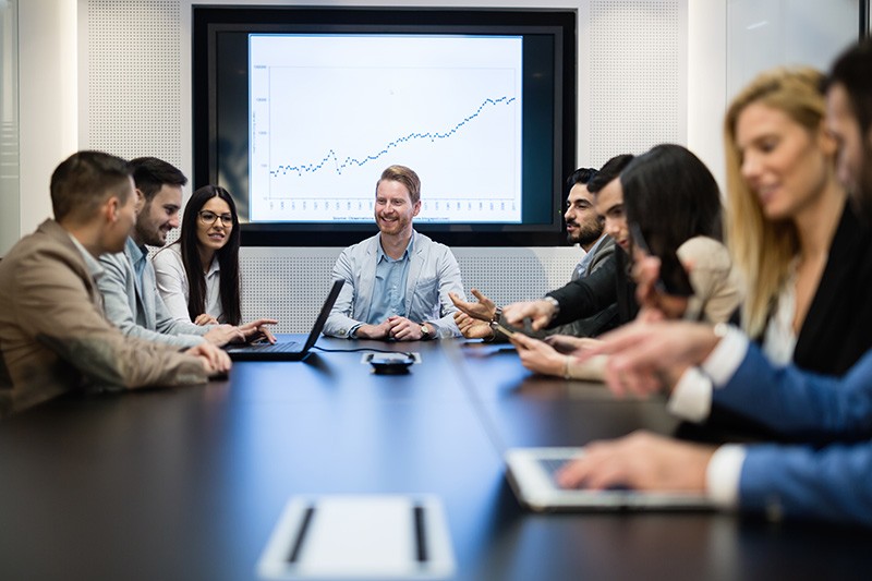 Boardroom meeting, discussing and analysing growth