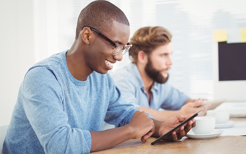 Casually dressed man using a tablet