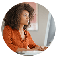 Women in orange shirt typing - Insight DE