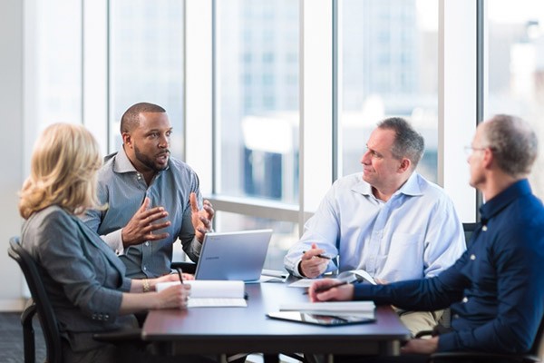 We can even help you ensure your data is secure Team discussion around table