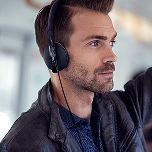 Contemporary Design Young man uses headphones in public