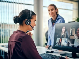 Young female office worker using a Sennheiser headset