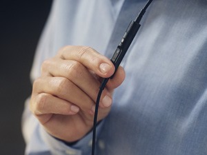 worker adjusts volume on headset