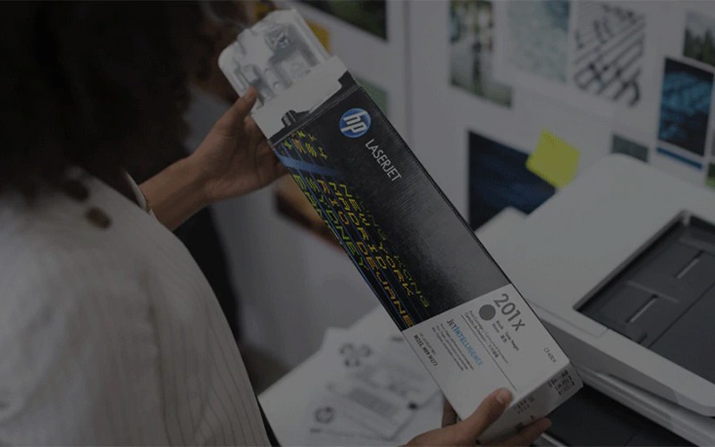 Protect yourself form counterfeit Woman holding a genuine HP toner cartridge