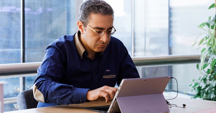 Person sitting at desk working on laptop
